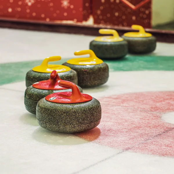 Group of curling rocks on ice close-up — Stock Photo, Image
