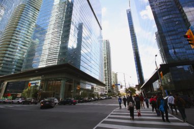city skyscrapers and people crossing the street