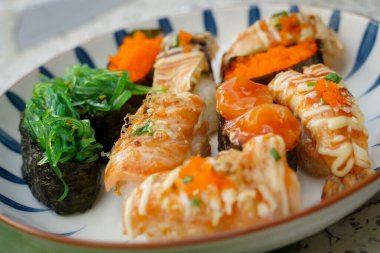 Çeşitli yüzlere sahip suşi seti basit Japon yemeğidir. Lezzetli deniz ürünleri. Suşi restoranı konsepti