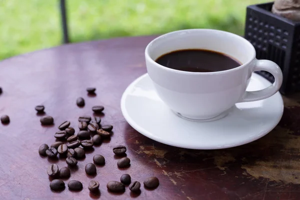 hot americano coffee on old wooden table.