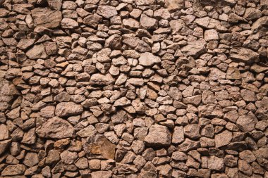 Eski taşlaşmış duvarın arka planı ve dokusu.