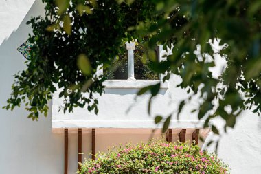white wedding arch with a candle on a background of a cemetery