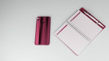 notebook and pencil with pink pen and a book on the white background.