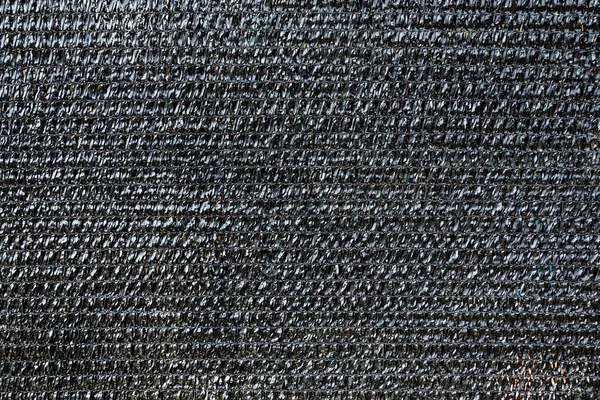 background of black shading net. Texture of plastic look plain and hard.