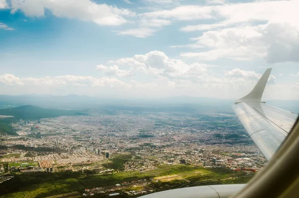 A Mexico City seen from the heights with urban areas and airplane landing zone