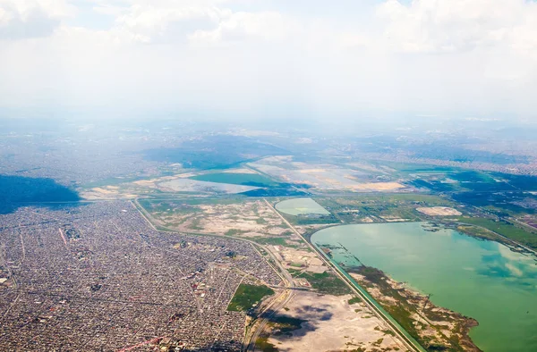 A Mexico City seen from the heights with urban areas and airplane landing zone