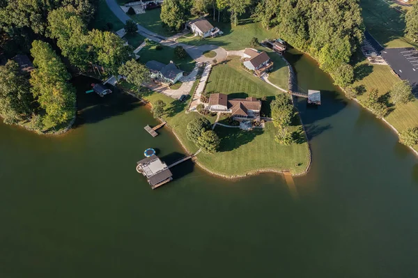 Aerial overhead view of lakefront homes and floating boat docks with upper deck and slide on Tims Ford Lake in Tennessee.