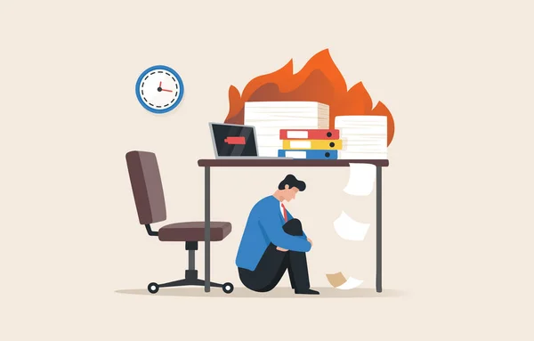 Burn out syndrome. low working efficiency. emotional exhaustion It is the result of excessive work stress. Lack of motivation to work leads to depression. A young man or an employee sits under the table.