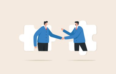 Business agreement partner or coordinating cooperation. Helping or building relationships leads to success. Businessmen handshake on jigsaw puzzle.