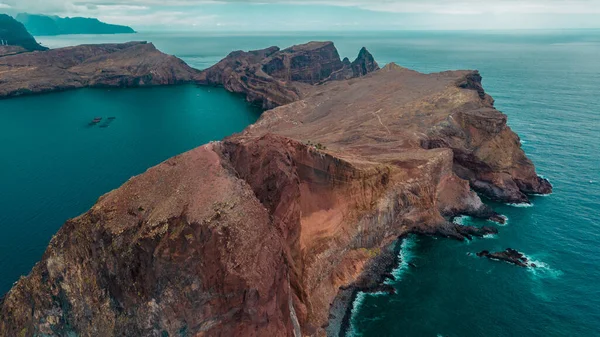 Peninsula, cape Ponta de Sao Lorenco in Atlantic ocean. Coastline with red cliffs, rocks and turquoise waves. Madeira island, Portugal. Aerial photography from drone. Breathtaking landscape.