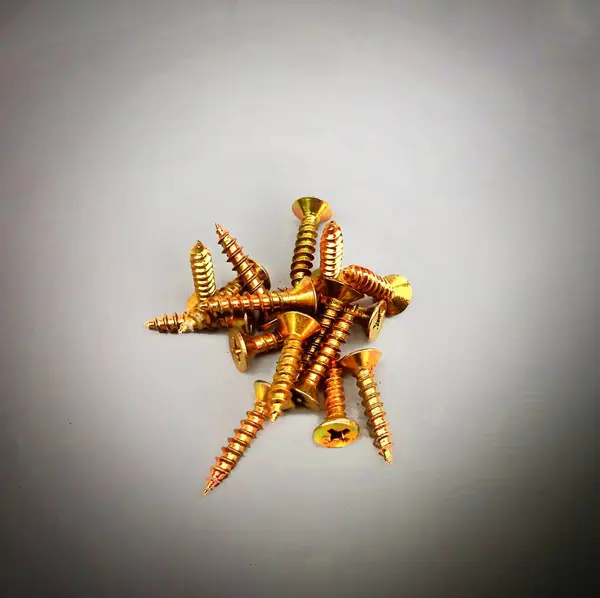 Selected focus, in a narrow field, Brass screws which are one of the building materials that function as hooks for various purposes