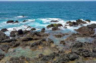 Rocks in the breakers on the coast of the Canary Island of Tenerife, Spain