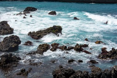 Rocks in the breakers on the coast of the Canary Island of Tenerife, Spain