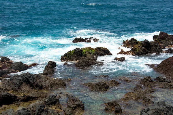 Rocks in the breakers on the coast of the Canary Island of Tenerife, Spain