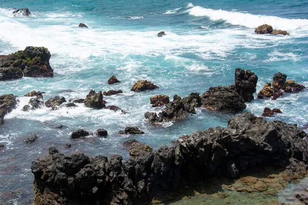 Rocks in the breakers on the coast of the Canary Island of Tenerife, Spain