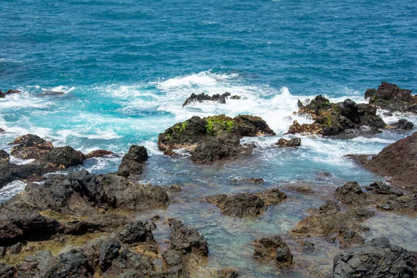 Rocks in the breakers on the coast of the Canary Island of Tenerife, Spain