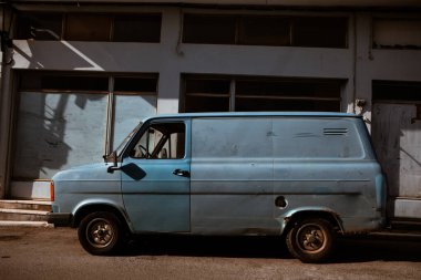 Old retro, blue-shaded truck on the street. Sunny summers day in the city