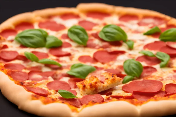 Side view of a yummy, juicy pepperoni pizza with basil - fast food