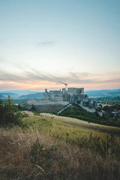 Huge medieval castle Bekov is a castle in ruins located near the village of Beckov in Nov Mesto nad Vhom District, Trenn Region, western Slovakia. Castle under reconstruction during the evening
