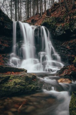Frosty waterfall Tosanovsky in autumn colours in a beautiful unforgiving part of the Beskydy Mountains in eastern Czech republic, central Europe.