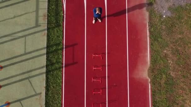 Blond Athlete Blue Shirt Develops His Dynamic Strength Jumping Hurdles — Video