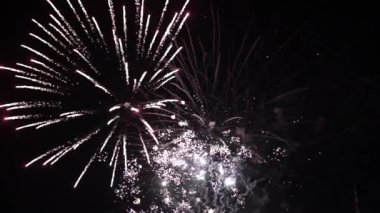 High quality FullHD footage. Great natural color . New years eve fireworks celebration loop seamless of real fireworks background. Multicolor golden shining glowing fireworks show with bokeh lights