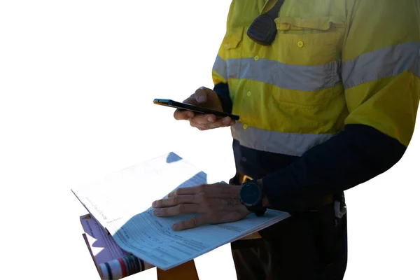 Safety work place miner supervisor checking site emergency phone number before sigh of confined space working at height permit prior to performing high risk work isolated with white background, Perth, Australia 