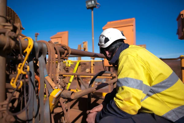 Industrial certified trained competent miner worker wearing working uniform helmet, personnel working as stand by hole watch confined space rescuer to control preventing, incident occurred at construction site Perth, Australia
