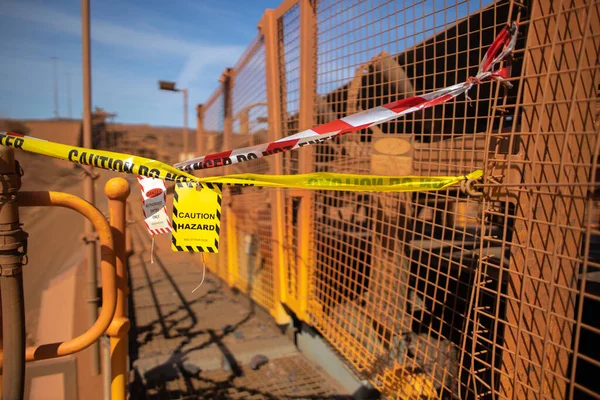 Safety work practices warning red and white danger tag yellow and black caution tag exclusion zone with signage barricading from public access into high risk work areas as danger dropped object zone