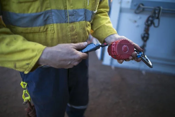 Safety work place trained competent inspector hands conducting testing shock shock absorber lanyard which connecting with an inertia reel shock absorbing fall protection device equipment ensuring is working correctly daily inspection prior used 