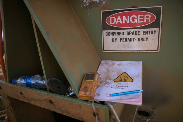 Safety work place danger confined space sign with gas detector and entry permit book placing at the  confined space entry door ready to used construction mine site Sydney Australia  