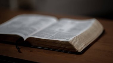Brown Bible from lower view sitting open on table