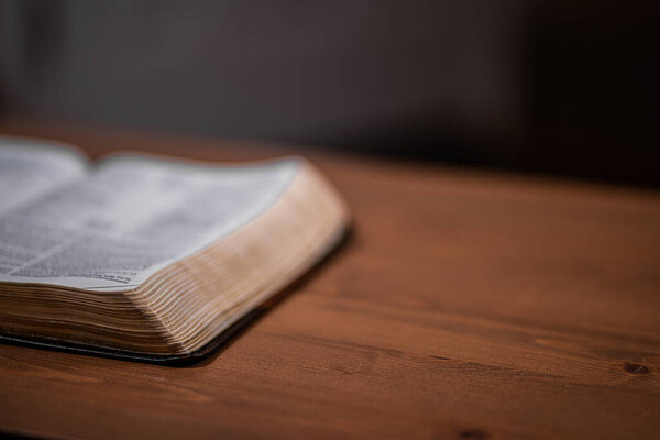 Open Bible from side view with table room for text