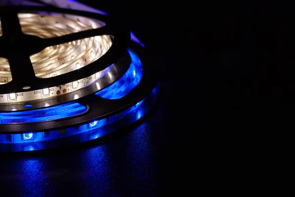 LED strip with blue and warm white SMD LEDs, with a black background