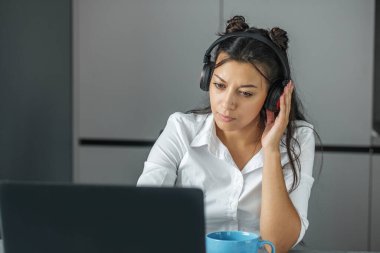 Young student is studying online. Office worker. Business woman working in the office. Convenient workplace. Remote work. Earn extra money. Money-making. Turning hobbies into cash. Skill-based work. Turning passion into job. Monetary rewards.