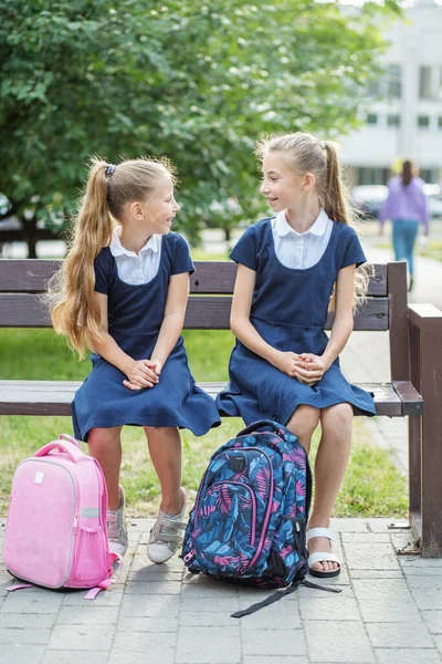 Two Children Schoolgirls Sit Bench School Have Fun Communicate Concept — Stockfoto