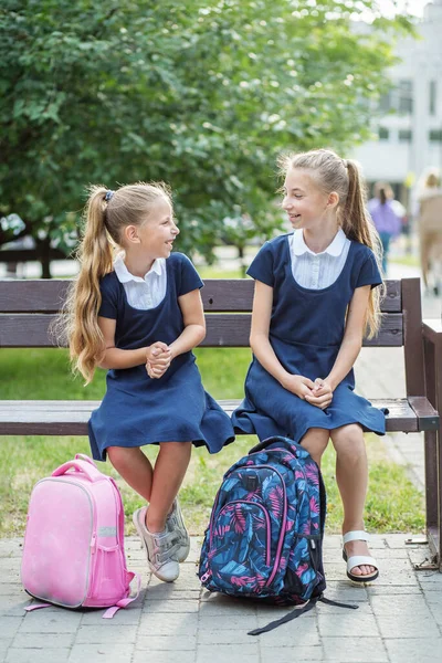 Two Children Schoolgirls Sit Bench School Have Fun Communicate Concept — 스톡 사진