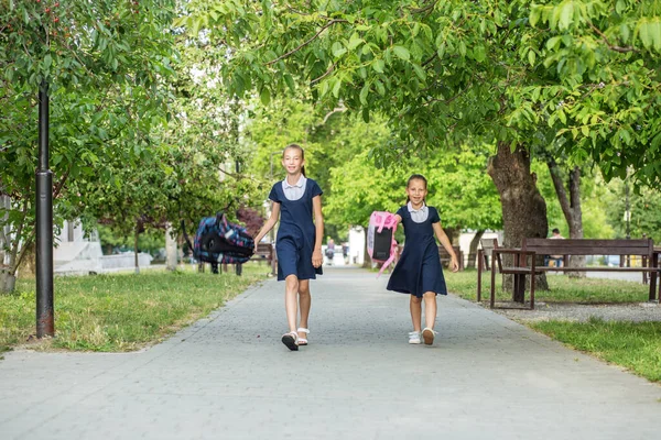 Two Schoolgirls School Throw Backpacks Children Having Fun Concept Back — Photo