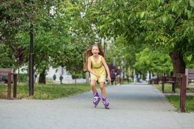 Child rollerblading fast at skate park. Having fun. Concept of an active lifestyle, hobbies and childhood