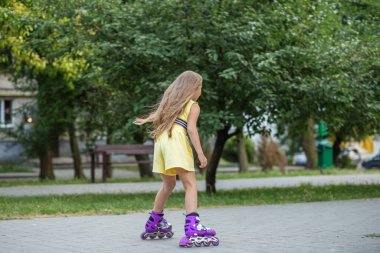 Child rollerblading fast at skate park. Concept of an active lifestyle, hobbies and childhood