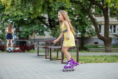 Child rollerblading fast at skate park. Having fun. Concept of an active lifestyle, hobbies and childhood