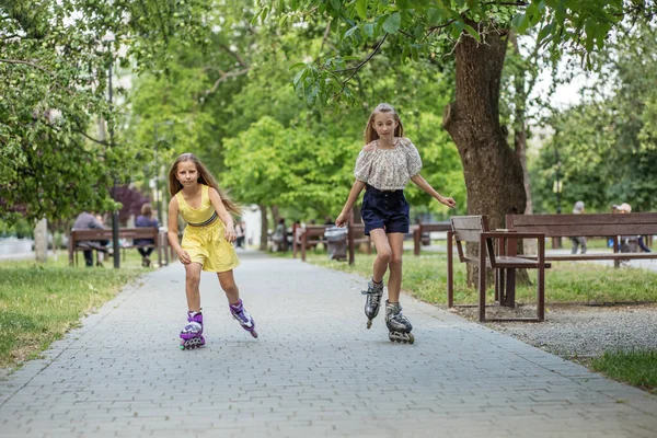 Two children are rollerblading at skate park. Concept of an active lifestyle, hobbies and childhood.