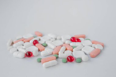Many different pills on white background. Copy space. Top view. Concept of pharmaceuticals, medicine and healthcare