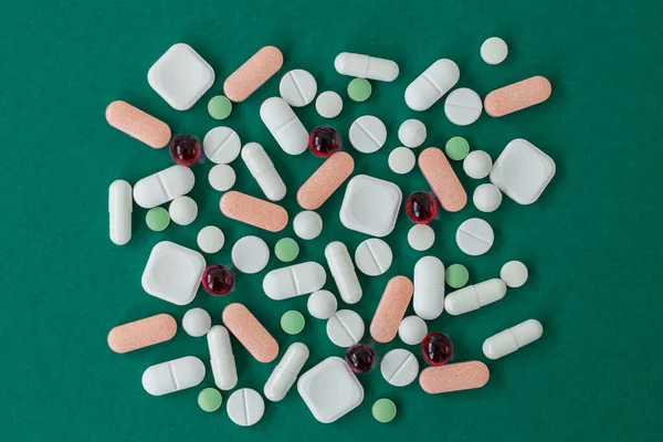 Many Different Pills Green Background Copy Space Top View Concept — Stockfoto