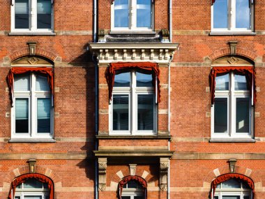 Sunlight on the windows and sunshades of an old brick office building in the business city centre. Utrecht, the Netherlands. Holland. Travel destination. High-quality photo.