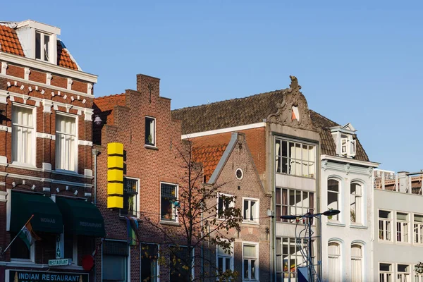 Autumn sun shining on historic storefronts downtown in the city of Utrecht, the Netherlands, Holland with a clear blue sky in the background. High quality photo