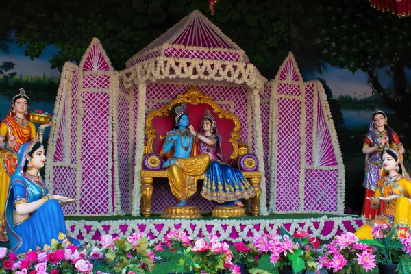 Stock image Colorful life size idols of Krishna, Radha sitting at Prem Mandir temple. Happy Krishna Janmashtami. selective focus on subject.