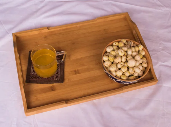 Healthy Indian Snack for slim fit, healthy lifestyle of men and women. Weight Loss and Diet Concept. healthy eating lifestyle. Makhana or foxnut, herbal tea. Selective focus on subject background blur