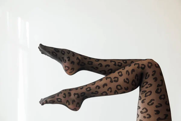 Beautiful womens slender legs in black tights — Stock Photo, Image