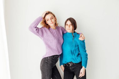 İki güzel moda bayan arkadaş kucaklaşıyorlar.